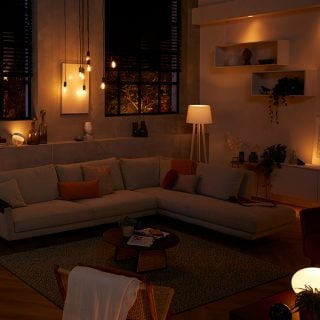 A living room lit in soft spring shades of pink, purple and white light.