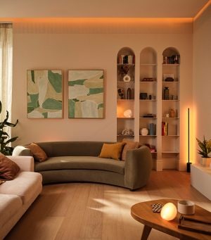 A living room with several Philips Hue lamps providing warm and cozy lighting.