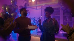 Menschen feiern fröhlich auf einer lebhaften Party mit einer stimmungsvollen Beleuchtung, die die festliche und energiegeladene Atmosphäre unterstreicht.