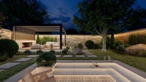 A back garden and patio seating area lit with outdoor smart lighting, including outdoor strip lights glowing in warm white tones of light.