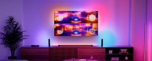  Philips Hue smart lights sync with split-screen racing gameplay on a TV in a modern living room.