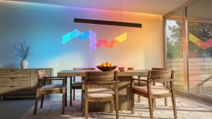 Nanoleaf modular wall light panels integrated with the Philips Hue app, creating colorful ambient lighting in a modern dining room.