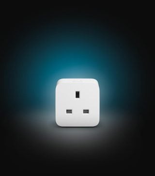 A Philips Hue smart plug in white.