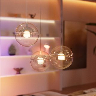 Three pendant lights fitted with non-smart bulbs glowing in white light.