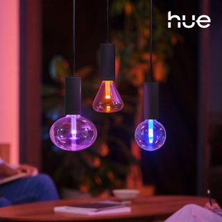 Hue smart Lightguide bulbs glowing in purple, orange, and blue.