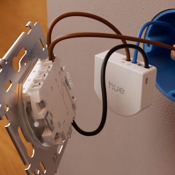 Close-up of a Philips Hue wall switch module connected to electrical wires
