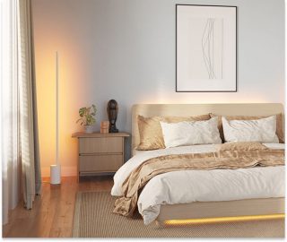 Modern bedroom featuring a Philips Hue Signe gradient floor lamp washing a wall in soft warm white light beside the bed.