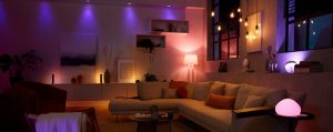 Contemporary living room with smart lighting solutions creating a soft ambient glow in purple, pink, and warm white tones.