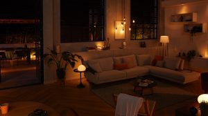 Living room with a sectional sofa illuminated by warm smart lighting, creating a soft ambient glow suitable for evening relaxation.