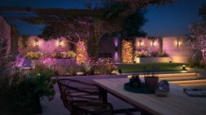 Garden illuminated by wall lanterns for front door