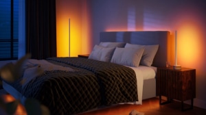 Bedroom with wall wash lighting casting a soft ambient glow in warm tones, highlighting the bed and nightstands