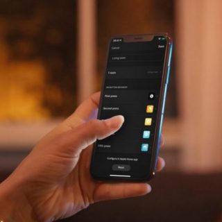Hand operating a smartphone, tapping screen to configure smart lighting settings for living room, with various options displayed.