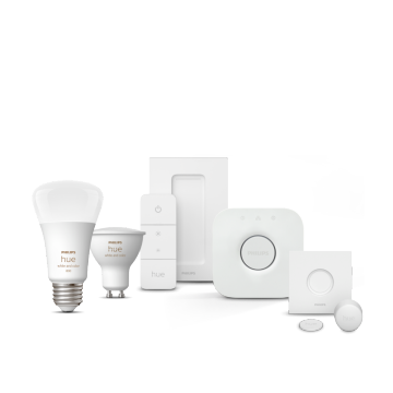 A collection of white smart bulbs, a remote control, a hub, a sensor, and a switch, all displayed against a white background.