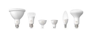 A collection of smart light bulbs in various shapes and sizes, all featuring white and color text on the product.