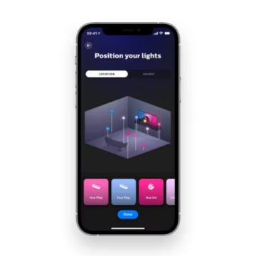 Smartphone screen displaying a lighting app interface with options to position colored smart lights in a virtual room.