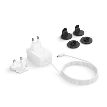 A white power adapter with interchangeable plugs, a long white cable, and a collection of black mounting clips on a white background.