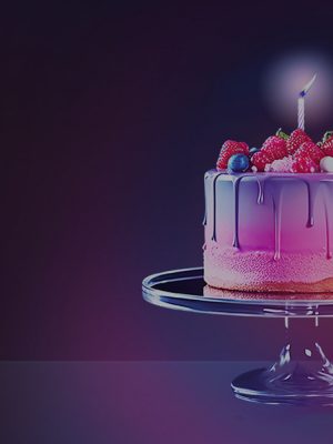 Birthday cake with pink frosting and berries on a glass stand, single candle lit, soft ambient glow in a dimly lit room.