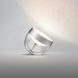Silver Iris smart table lamp with a rounded transparent base, glossy finish, compact design, and illuminated top section.