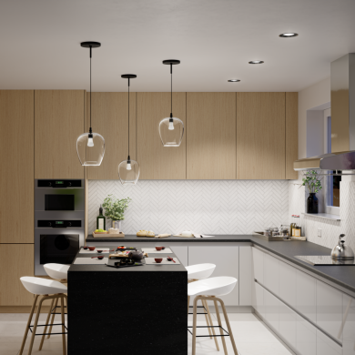 Pendant smart light bulbs with clear glass shades are suspended above a kitchen island, illuminating the countertop workspace.
