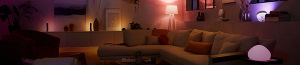 A living room lit with a range of Philips Hue smart lamps promoting the last chance clearance sale.