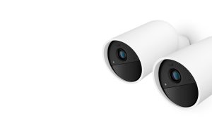 Collection of cylindrical, matte white smart security cameras with black circular lens area and visible sensors.