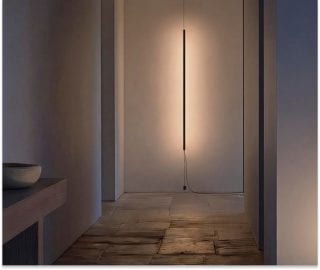 Salon moderne illuminé par des luminaires suspendus Philips Hue Signe au plafond et des éclairages muraux Signe, créant une atmosphère chaleureuse et invitante.